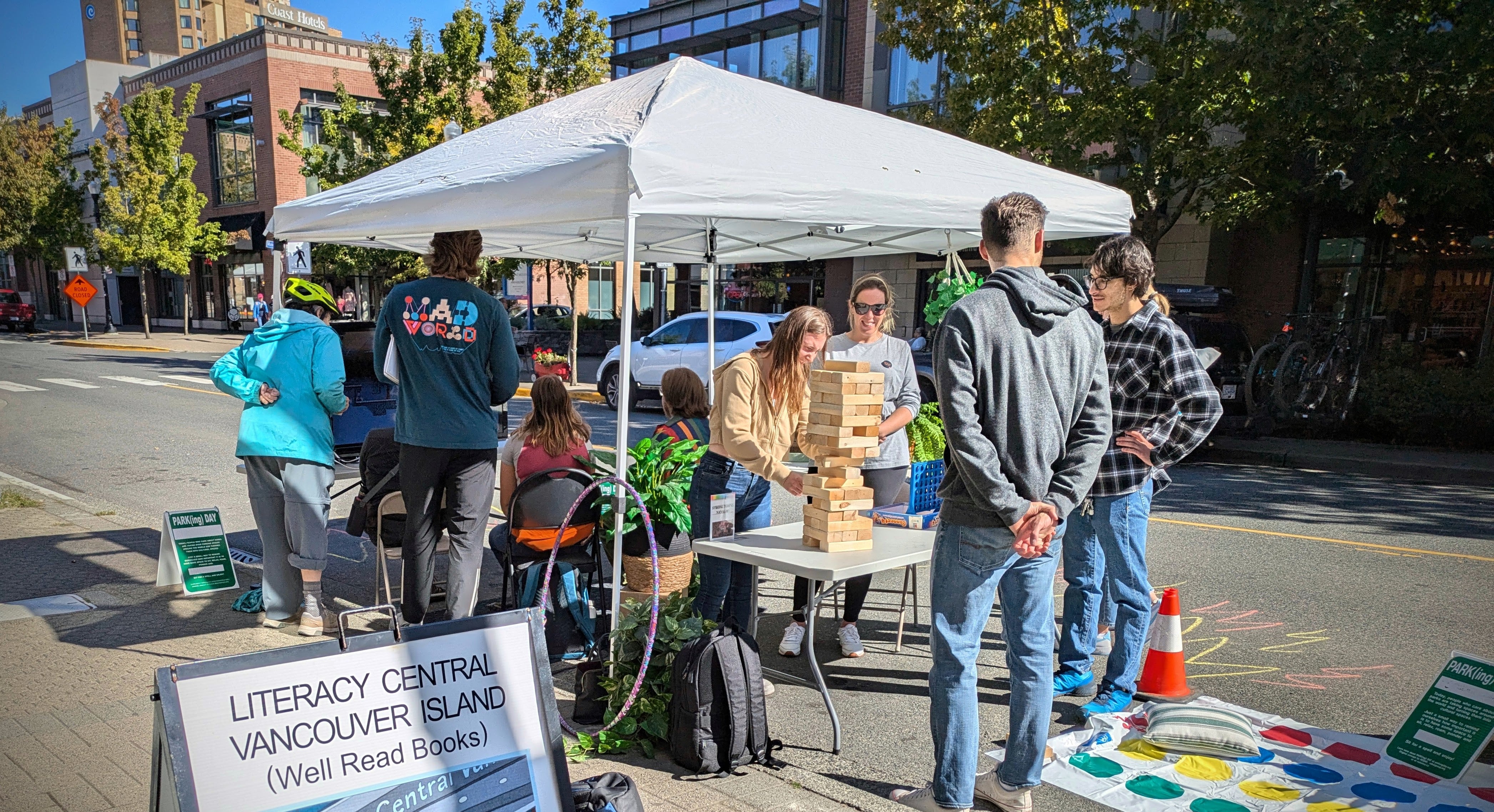 Our contribution to Park(ing) Day 2024. Strong Towns Nanaimo transformed a single parking space into an outdoor living room, complete with a TV, seating, board games, Twister, and more! (Strong Towns Nanaimo)